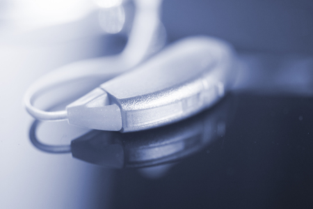 Audiophone modern high technology deafness equipment in the ear digital hearing aid closeup...