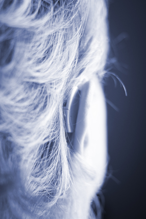 Deaf lady with modern technology digital hearing aid in her ear.の写真素材