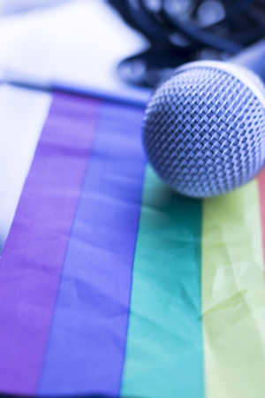 Gay lesbian LGBT rights homosexual pride flag with rainbow mutlicolor design and professional microphone.の写真素材
