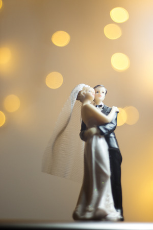 Wedding ceremony marriage bride groom cake topper figures with lights isolated.の写真素材