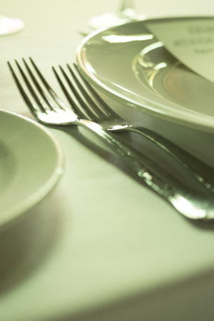 Wedding reception banquet dinner party table place settings set in luxury hotel venue.の写真素材