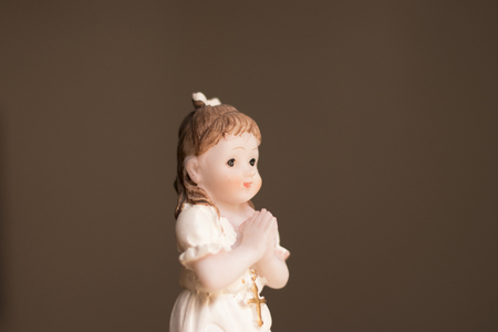 Cake topper Catholic holy communion ceremony religious girl praying to Christian God in church.の写真素材