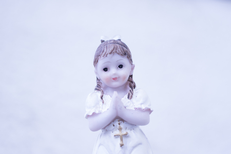 Cake topper Catholic holy communion ceremony religious girl praying to Christian God in church.の写真素材