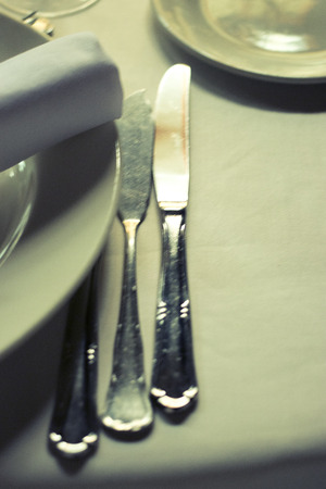 Wedding reception banquet dinner party table place settings set in luxury hotel venue.の写真素材