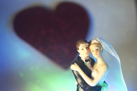 Wedding couple marriage cake topper plastic figures with tuxedo evening suit, white weddding dress veil.の写真素材