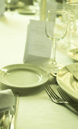 Wedding reception banquet dinner party table place settings set in luxury hotel venue.の写真素材