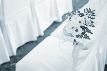 Outdoor summer garden civil wedding seating with flower bouquets decorated for marriage service.の写真素材