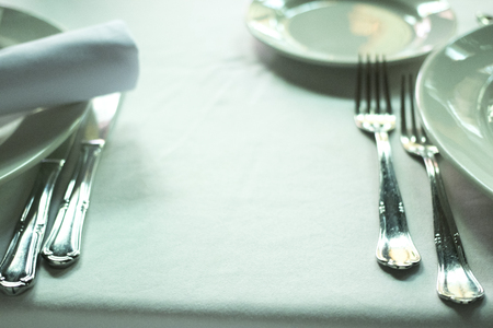 Wedding reception banquet dinner party table place settings set in luxury hotel venue.の写真素材
