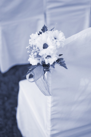 Outdoor summer garden civil wedding seating with flower bouquets decorated for marriage service.の写真素材