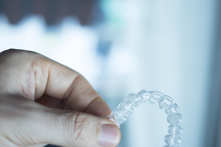 Invisible dental teeth aligners brackets used to align each tooth in cosmetic dentistry for patients.の写真素材