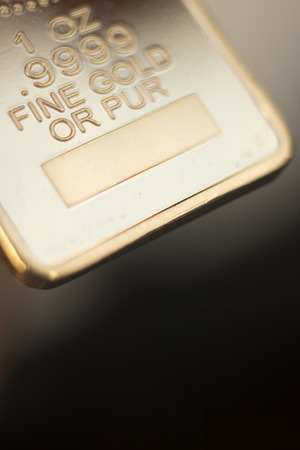 Gold bullion 999.9 purity solid one ounce ingot precious metal bars.の写真素材