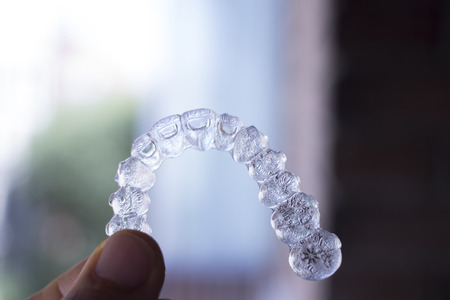 Invisible dental teeth aligners brackets used to align each tooth in cosmetic dentistry for patients.の写真素材