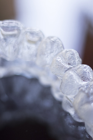 Invisible dental teeth aligners brackets used to align each tooth in cosmetic dentistry for patients.の写真素材