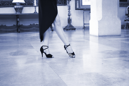 Ballroom latin salsa hot sexy female dancer dancing in modern sport dance showwith slim long legs,の写真素材