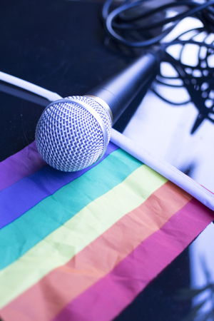 Gay lesbian LGBT rights homosexual pride flag with rainbow mutlicolor design and professional microphone.の写真素材