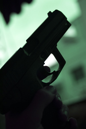 Automatic pistol handgun in artistic light effect moody atmospheric photo closeupの写真素材