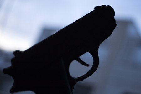 Automatic pistol handgun in artistic light effect moody atmospheric photo creative artistic closeupの写真素材