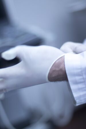 Doctor medical glove on hand in hospital clinic center.