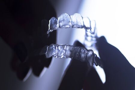 Clear dental teeth retainer brackets to straighten and align each tooth in modern dentistry technology.の写真素材