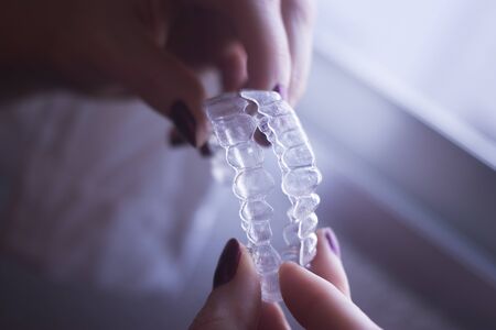 Clear dental teeth retainer brackets to straighten and align each tooth in modern dentistry technology.の写真素材