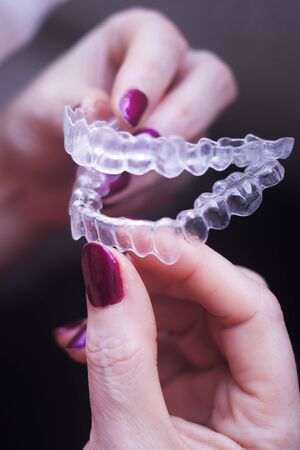 Clear dental teeth retainer brackets to straighten and align each tooth in modern dentistry technology.の写真素材