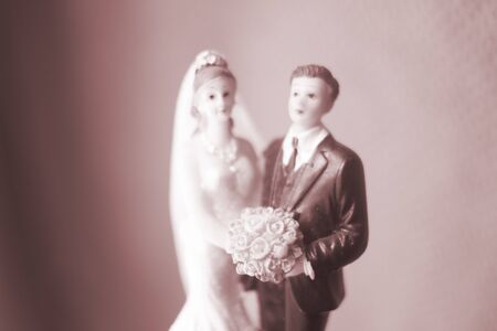 Wedding couple marriage cake topper plastic figures with tuxedo evening suit, white weddding dress veil.の写真素材