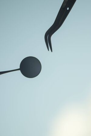 Dentists dental equipment mirror and tooth pick to remove plaqueの写真素材