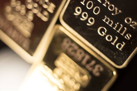 Fine solid gold 999.9 one ounce bullion ingot precious metals bar closeup isolated photo.の写真素材