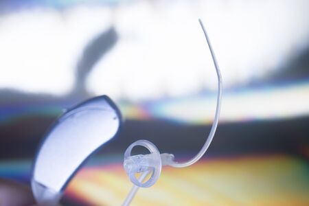Modern high technology digital hearing aid closeup isolated.