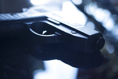 Automatic pistol handgun in artistic light effect moody atmospheric photo creative artistic closeupの写真素材