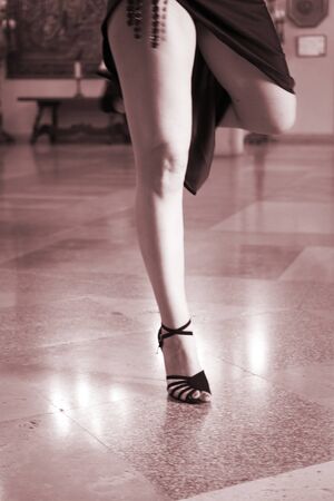 Ballroom latin salsa hot sexy female dancer dancing in modern sport dance showwith slim long legs,の写真素材
