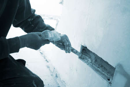 Building renovation works in appartment work by builders to renovate walls.