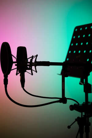 Voiceover studio large diaphragm cardioid microphone, headphones and lectern in professional voice recording studios.の写真素材