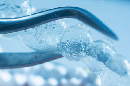 Modern invisible brackets aligner straighterners used to correct alignment on teeth by dentists.の写真素材