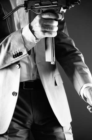 Retro secret agent with porstol revolver gun in hand in vintage crime thriller mockup cover     photo.の写真素材