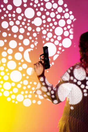 Lady spy detective holding pistol gun.の写真素材