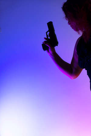 Lady spy detective holding pistol gun.の写真素材
