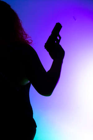 Lady spy detective holding pistol gun.の写真素材