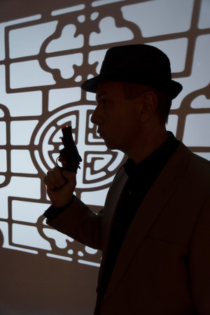 Spy thriller book cover design with man holding pistol gun.の写真素材