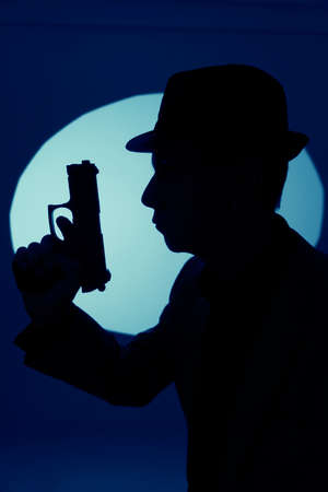 Spy thriller book cover design with man holding pistol gun.