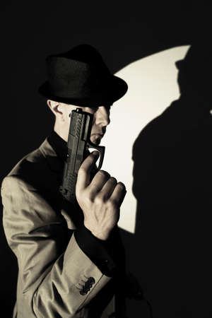 Spy thriller book cover design with man holding pistol gun.の写真素材