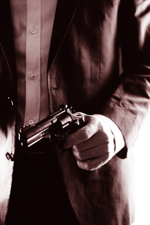 Retro secret agent with pistol revolver gun in hand in vintage crime thriller mockup cover     photo.の写真素材