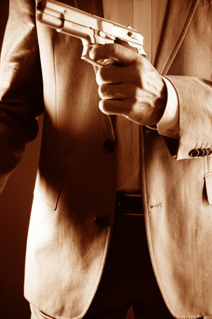 Retro secret agent with pistol revolver gun in hand in vintage crime thriller mockup cover     photo.の写真素材