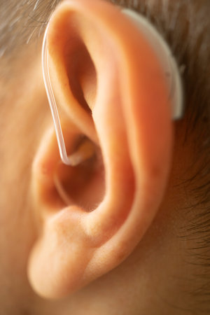 Modern digital hearing aid in ear of middle aged 40s 50s manの写真素材