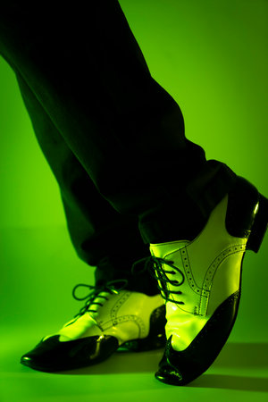 Male dancer dancing in jazz latin ballroom shoes with plain color backgroundの写真素材
