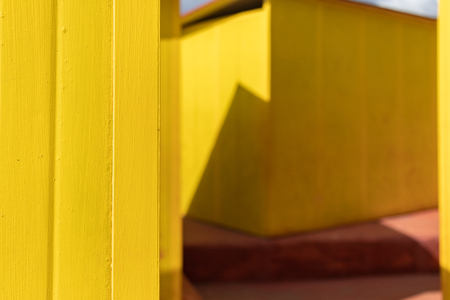 Beautiful yellow Bathing houses on sandy beach. Empty shelters on a sunny but moody day.の写真素材