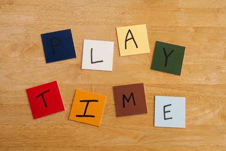PLAY TIME written in letters on square tiles on wooden background - for education / schools / teachers!の写真素材