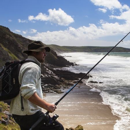 Fisherman Gazing at the Beach and Wild Sea の写真素材