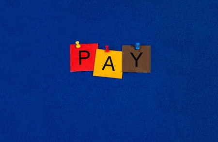 Pay - Business terms sign series, tiles and letters on noticeboard with pins.の写真素材