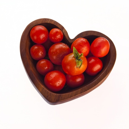 Red Tomatoes in Love Heart Shaped Bowl - Isolated on White Backgroundの写真素材